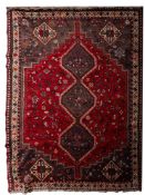 A Shiraz carpet, the red field with a grey triple stepped hexagonal pole medallion, scattered bird,