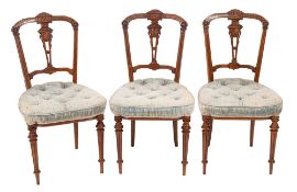 A set of six Victorian carved walnut salon chairs,