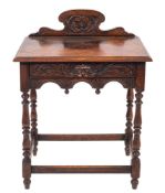 A late Victorian carved oak rectangular side table with shaped ledge back and C-scroll panel,