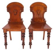 A pair of George IV oak hall chairs,