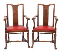 A pair of Edwardian oak open armchairs,