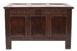 A 17th Century oak rectangular coffer of moulded panel construction with a hinged top,