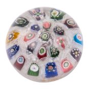 A Clichy spaced millefiori concentric ring paperweight with central 'rose' canes surrounded by two