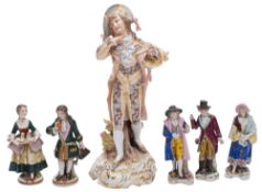 A group of Continental porcelain figures, comprising a Sitzendorf dandy on a gilt scrolling base,
