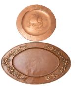 A Newlyn repoussé worked copper charger, early 20th century; circular,