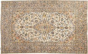 A Kashan carpet, the ivory cartouche field with a central beige cartouche pole medallion,