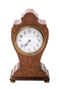 A Edwardian mahogany balloon clock the French eight-day duration movement having a platform lever