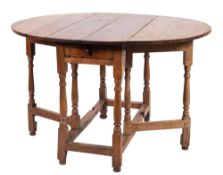 A William and Mary oak gateleg table, late 17th century; the oval top above a drawer at one end,