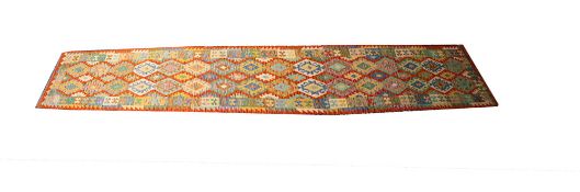 An Anatolian Kelim runner, the lozenge serrated and hooked field in rust, powder blue,