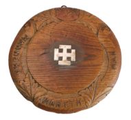 A carved oak and silver mounted Winchester College bread board,