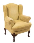 A stained beech wing frame armchair fully upholstered in lime green folkweave fabric,