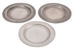 A pair of pewter chargers, late 18th /early 19th century; with broad, flat rims,