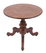A circular low occasional table with a mahogany top,