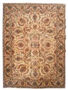 A Tabriz carpet, the ivory field with an all over design of palmettes and scrolling floral foliage,