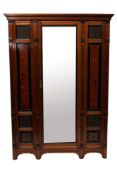 A Victorian mahogany, ebonised and amboyna veneered wardrobe in Aesthetic Movement style,