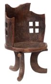 An East African carved hardwood tub chair, probably Guraje people; hewn from a single piece,