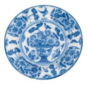 A blue and white delftware charger, German or Dutch painted with a large vase of flowers,