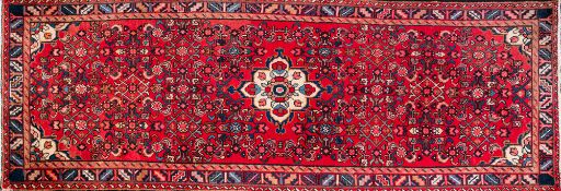 A Hamadan rug, second half 20th century; with flowers and foliage in a central ivory medallion,