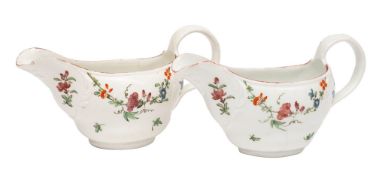 A pair of Bristol sauceboats of oval ogee form with moulded scrollwork borders,