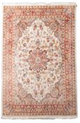 A Persian rug, machine made, with an ivory cartouche field, all over designs and main rust border,