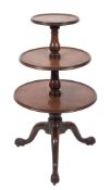 A George III mahogany circular three tier graduated dumb waiter with ring turned baluster column