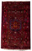 A Hamadan rug, the wine field with a blue octagonal stellar medallion,