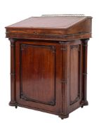 A Regency mahogany Davenport the sliding superstructure with a pierced brass ledge gallery,