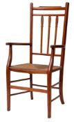 A stained hardwood and rush seated open elbow chair,
