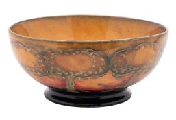 A William Moorcroft bowl the interior and exterior tube lined in warm tones in the Eventide pattern,