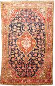 A Joshegan rug, the indigo field with a central brick red shaped lozenge pole medallion,