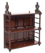 An early 19th Century mahogany three tier hanging bookcase with fret carved stylised foliate