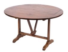 A 19th Century French fruitwood circular wine tasting or vendange table,