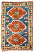 A Melas rug, the pastel blue field with triple brick red hooked octagonal medallions,
