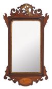 An Edwardian mahogany and partly gilt fret carved wall mirror in the George III taste,