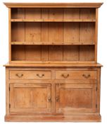 A Victorian pine dresser, late 19th century; the plate rack with cornice above open shelves,