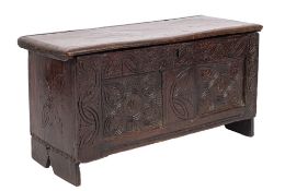 A Charles II oak coffer, circa 1670; the hinged cover above a two panel front,