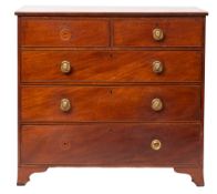 A George III mahogany chest of drawers, early 19th century; the top with banded edging,