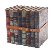 A Victorian polychrome painted novelty biscuit tin modelled as eight bound leather books,