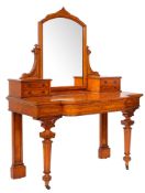 A late Victorian satinwood breakfront dressing table, the arched mirror,