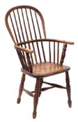 A Victorian elm and ash hoop back Windsor chair, probably Thames Valley, with iron re-forced arms,