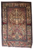 A Kirman prayer rug, the beige mihrab with a Tree of Life design of animals and flowering trees,