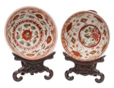 Two Chinese Swatow bowls painted with figures, phoenix, flowers and foliage in iron-red,