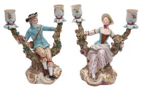 A pair of Meissen two-branch figural candleabra in the form of a gallant and companion seated