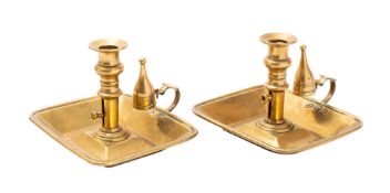 A pair of Regency brass ejector chambersticks,