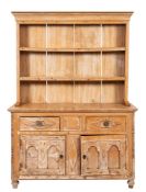 A Cornish pine dresser, the shelved superstructure with a moulded cornice,