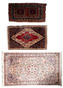 A Kashmir rug, the ivory field with a powder blue flowerhead medallion,