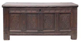A Charles II oak coffer, circa 1670; with hinged cover above a simple chip carved frieze,