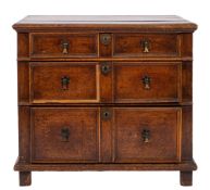 A late 17th Century and later oak chest with three panelled drawers and on stile feet; 82cm high,