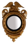 A giltwood framed convex wall mirror in Regency style,