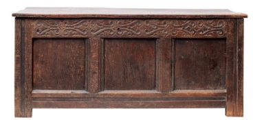 A Carolean oak coffer, circa 1640; with hinged cover,